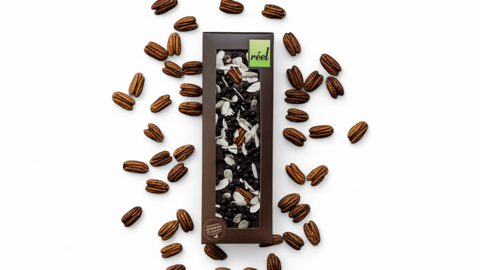 6933fc337f812b4452a33cfb Reel Tamna čokolada 70% borovnica, badem i pekan orah 115g - Slika 1